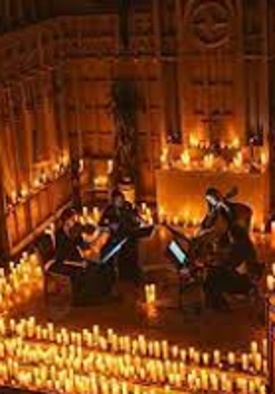 Photo of two musicians on stage, around them many lit candles.