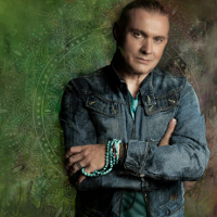 Photo of Maciej Balcar, green background.