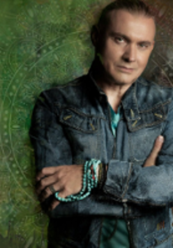 Photo of Maciej Balcar, green background.