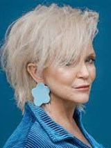 Photo of Małgorzata Ostrowska, blue background.