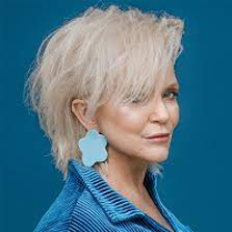 Photo of Małgorzata Ostrowska, blue background.