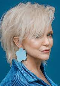Photo of Małgorzata Ostrowska, blue background.