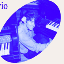 Photo of Marcin Masecki sitting at the piano. Picture in blue colours.