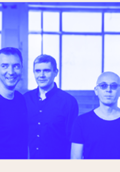 Blue-coloured photo of three men.