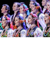 Photo of the women and men in two rows in traditional folk costumes.