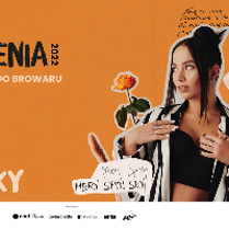 Picture of the artist on orange background among flowers