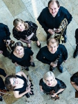 Photo of the music band - a group of musicians with their instruments looking up to the camera