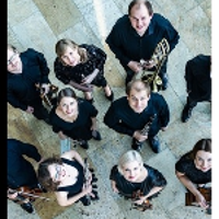 Photo of the music band - a group of musicians with their instruments looking up to the camera