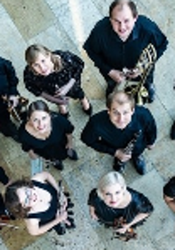 Photo of the music band - a group of musicians with their instruments looking up to the camera