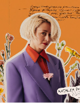 Picture of the artist on orange background among flowers