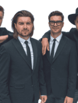 Photo of the band - four men in suits.