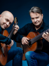 Photo of two artists playing the guitars