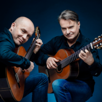 Photo of two artists playing the guitars
