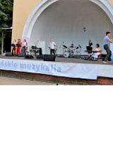 Photo of a Concert Shell in Wilson Park with artists performing on stage.