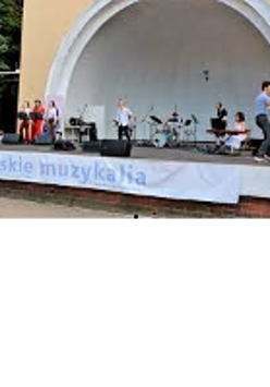 Photo of a Concert Shell in Wilson Park with artists performing on stage.