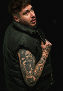 Photo of the young man with numerous tattoos on his arm.