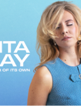 Photo of Rita Ray - a blonde woman with closed eyes.