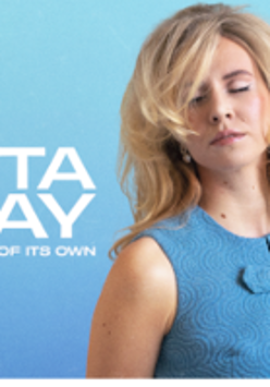 Photo of Rita Ray - a blonde woman with closed eyes.