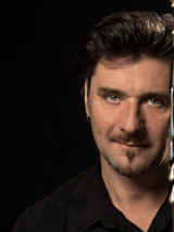 Photo of Ronan Le Bars, black background.