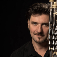 Photo of Ronan Le Bars, black background.