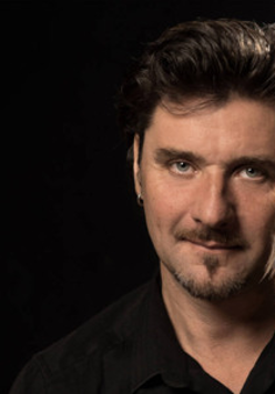 Photo of Ronan Le Bars, black background.
