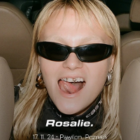 Photo of a young woman in black sunglasses; she has her mouth open and shows her tongue.