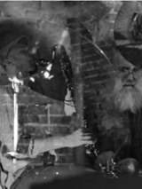 Black and white photo of two musicians by their musical instruments.