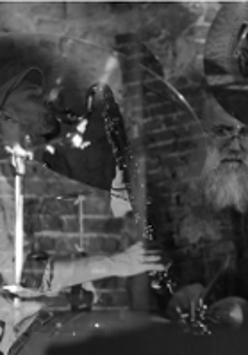Black and white photo of two musicians by their musical instruments.