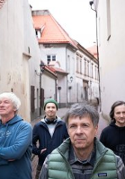 Photo of the band's members on a narrow street.