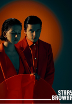 Photo of young woman and man dressed in red clothes. Red background