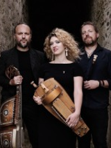 Photo of the Trio - a woman between two men.