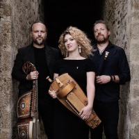 Photo of the Trio - a woman between two men.