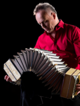 Photo of the musician Wiesław Prządka playing bandoneon.
