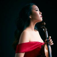 Photo of the artist - Stella Chen holding a violin in her hand