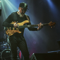 Photo of the artist - a man on stage playing the guitar