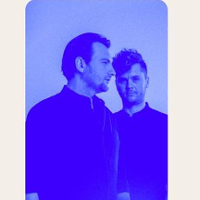 Photo of two men in blue colours.