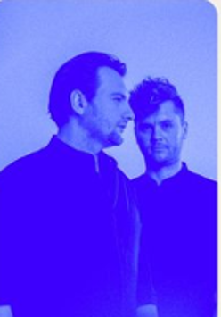 Photo of two men in blue colours.