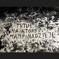 On the black background there is an inscription made of white particles spread apart: "The title we are hoping for".