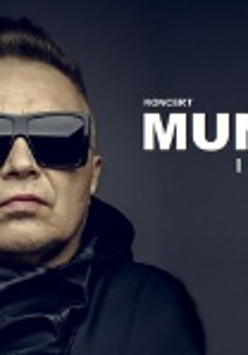 Photo of Muniek Staszczyk - a man in dark sunglasses and black jacket. On the right - white inscription "Muniek i przyjaciele". Dark grey background.