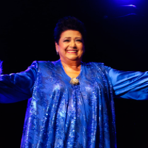 Photo of the singer - a woman in blue dress