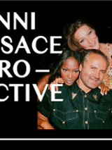 Poster: photo of Gianni Versace and two women behind him and the title of the exhibition.