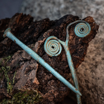 Photo of two exhibits in blue colour against the background of a rock.