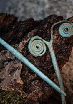 Photo of two exhibits in blue colour against the background of a rock.