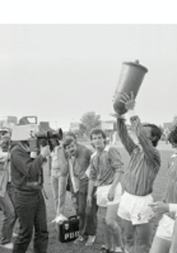 Exhibition poster - black and white photo of the football players, one of them holding a trophy.