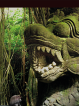 Photo of stone sculpture among exotic plants.