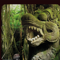 Photo of stone sculpture among exotic plants.