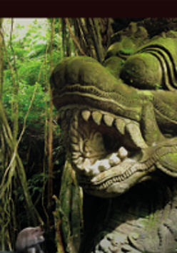 Photo of stone sculpture among exotic plants.
