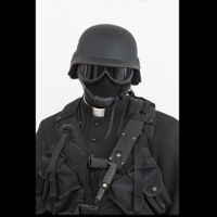 Black and white photo of a soldier wearing a helmet, mask and dark goggles.