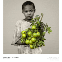 One of the exhibition photos - black and white photo of a boy holding green-yellow lemons.
