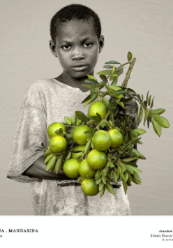 One of the exhibition photos - black and white photo of a boy holding green-yellow lemons.